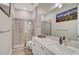 Bathroom with a walk-in shower and double vanity at 6625 Dovekey Dr, Sarasota, FL 34241