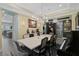 Elegant dining room featuring a large table, chandelier, and piano at 6625 Dovekey Dr, Sarasota, FL 34241