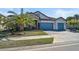 Two-story house with light gray walls and blue garage doors at 6625 Dovekey Dr, Sarasota, FL 34241