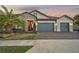 Two-story house with three-car garage and landscaped yard at 6625 Dovekey Dr, Sarasota, FL 34241