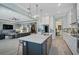 Open concept kitchen with island and view into living room at 6625 Dovekey Dr, Sarasota, FL 34241