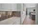 Modern kitchen with white cabinets, quartz counters, and wood flooring at 6625 Dovekey Dr, Sarasota, FL 34241