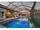 Relaxing pool and spa area with covered lanai and fire pit at 6625 Dovekey Dr, Sarasota, FL 34241