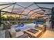 Relaxing pool and patio area with fire pit and lake view at 6625 Dovekey Dr, Sarasota, FL 34241