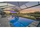 Covered lanai with a refreshing pool, spa, and fire pit at 6625 Dovekey Dr, Sarasota, FL 34241