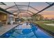 Enjoy sunset views from this covered lanai with a pool and spa at 6625 Dovekey Dr, Sarasota, FL 34241