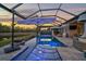Resort-style pool area with covered lanai and fire pit at 6625 Dovekey Dr, Sarasota, FL 34241