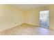 Cozy bedroom with tile flooring and a window with blinds at 6704 11Th W Ave, Bradenton, FL 34209