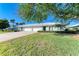 Front view of a light-blue villa with a two-car garage and lush lawn at 6704 11Th W Ave, Bradenton, FL 34209