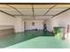 Spacious garage with green epoxy floor and access door at 6704 11Th W Ave, Bradenton, FL 34209