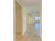 Hallway with neutral walls, tiled floors and a linen closet at 6704 11Th W Ave, Bradenton, FL 34209