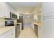 Modern kitchen with stainless steel appliances and white cabinets at 6704 11Th W Ave, Bradenton, FL 34209