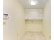 Empty laundry room with overhead cabinets and tile floor at 6704 11Th W Ave, Bradenton, FL 34209