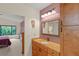 Bathroom boasts wood cabinets, granite countertop, and a view of the bedroom at 7340 Silver Fern Blvd # 5, Sarasota, FL 34241