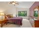 Main bedroom with large window, walk-in closet, and dresser at 7340 Silver Fern Blvd # 5, Sarasota, FL 34241