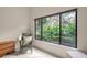 Bedroom with large window and wicker chair at 7340 Silver Fern Blvd # 5, Sarasota, FL 34241