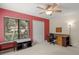 Spacious bedroom with red accent wall, large window, and ceiling fan at 7340 Silver Fern Blvd # 5, Sarasota, FL 34241