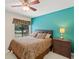 Bedroom features a ceiling fan, large window, and plenty of space at 7340 Silver Fern Blvd # 5, Sarasota, FL 34241