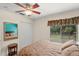Bright bedroom with large window, ceiling fan, and mirrored wall at 7340 Silver Fern Blvd # 5, Sarasota, FL 34241
