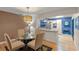 Bright dining area with glass table and kitchen access at 7340 Silver Fern Blvd # 5, Sarasota, FL 34241