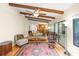 Living room with hardwood floors, wood beams, and view into dining area at 7340 Silver Fern Blvd # 5, Sarasota, FL 34241