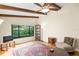 Living room with hardwood floors, large window, and access to backyard at 7340 Silver Fern Blvd # 5, Sarasota, FL 34241