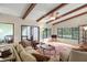 Bright living room with hardwood floors, wood beams, and access to a screened porch at 7340 Silver Fern Blvd # 5, Sarasota, FL 34241