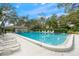 Community pool with plenty of lounge chairs at 7340 Silver Fern Blvd # 5, Sarasota, FL 34241