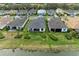 Aerial view of community homes near lake at 9048 Bernini Pl, Sarasota, FL 34240