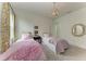 Charming bedroom with twin beds, floral curtains, and a decorative mirror at 9048 Bernini Pl, Sarasota, FL 34240