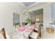 Bright dining room with a floral tablecloth and pink accents at 9048 Bernini Pl, Sarasota, FL 34240