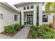 Front entry with double doors, landscaping, and walkway at 9048 Bernini Pl, Sarasota, FL 34240