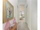 Bright hallway with art and view of bedroom at 9048 Bernini Pl, Sarasota, FL 34240