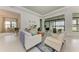 Bright living room with white sofas and access to patio at 9048 Bernini Pl, Sarasota, FL 34240