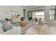 Spacious living room with sliding glass doors opening to a lake view at 9048 Bernini Pl, Sarasota, FL 34240