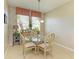 Bright breakfast nook boasts a glass-top table and four chairs, near kitchen at 11306 77Th E St, Parrish, FL 34219