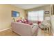 Living room with light beige sofa and pink accent chairs at 11306 77Th E St, Parrish, FL 34219