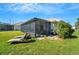 Attractive backyard with screened lanai and lounge chairs at 11467 Conch Ct, Venice, FL 34292