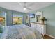 Bright bedroom with king-size bed, built-in TV, and plenty of natural light at 11467 Conch Ct, Venice, FL 34292