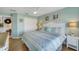 King-size bed, built in TV and dresser, and soft, natural light at 11467 Conch Ct, Venice, FL 34292