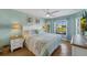 Spacious bedroom with king-size bed and large window overlooking backyard at 11467 Conch Ct, Venice, FL 34292