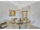 Charming dining area with a glass-top table and wicker chairs at 11467 Conch Ct, Venice, FL 34292