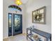 Bright entryway with decorative glass door and elegant console table at 11467 Conch Ct, Venice, FL 34292