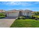 Attractive home exterior with landscaping and brick driveway at 11467 Conch Ct, Venice, FL 34292