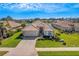 Single-story house with a tile roof, landscaped yard, and brick driveway at 11467 Conch Ct, Venice, FL 34292