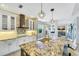 Modern kitchen featuring granite countertops, stainless steel appliances, and white cabinetry at 11467 Conch Ct, Venice, FL 34292