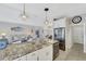 Island kitchen with granite countertops, stainless steel appliances, and white cabinets at 11467 Conch Ct, Venice, FL 34292