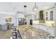 Modern kitchen with granite countertops, stainless steel appliances, and white cabinets at 11467 Conch Ct, Venice, FL 34292
