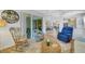 Open living space with comfortable seating, access to the patio, and a tranquil atmosphere at 11467 Conch Ct, Venice, FL 34292