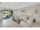 Relaxing living room with light-colored furniture and access to a patio at 11467 Conch Ct, Venice, FL 34292